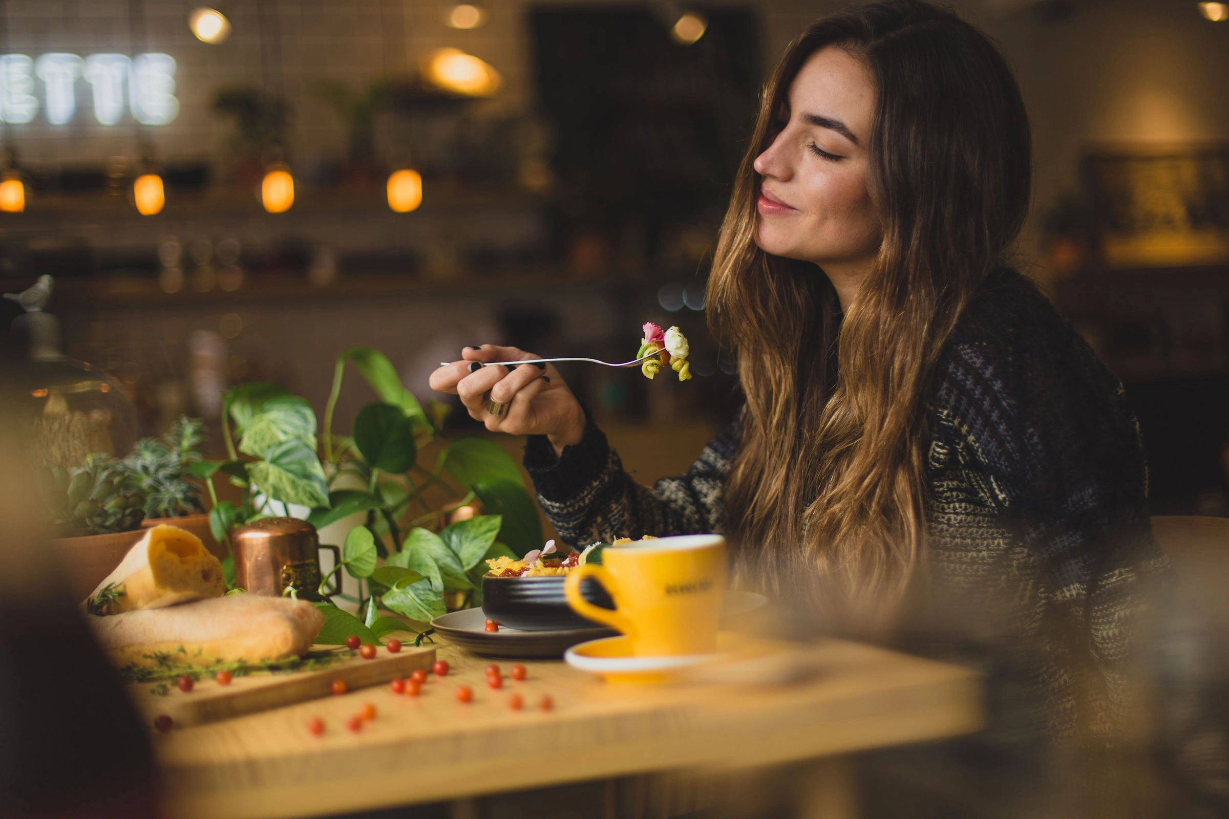 women enjoy eating meal in resturant